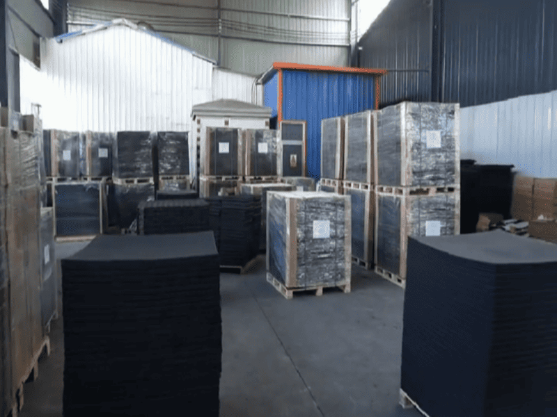 High quality vulcanized rubber floor tiles stacked in a warehouse